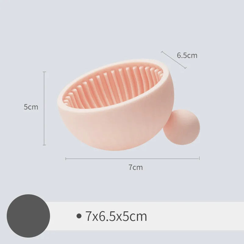 Small silicone makeup brush cleaning scrub tray in white with raised textured centre for removing foundation residue