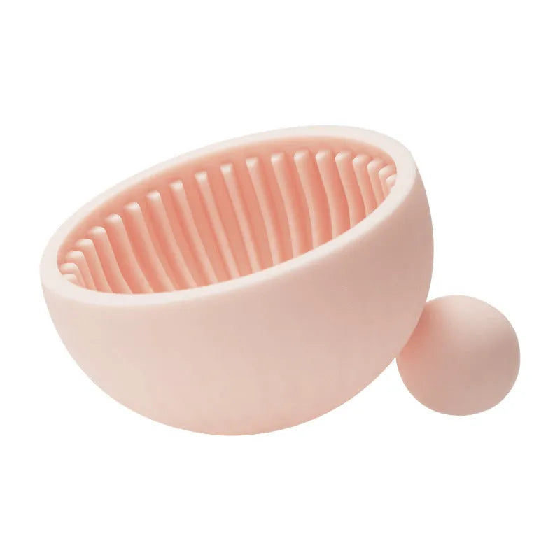 Small silicone makeup brush cleaning scrub tray in white with raised textured centre for removing foundation residue