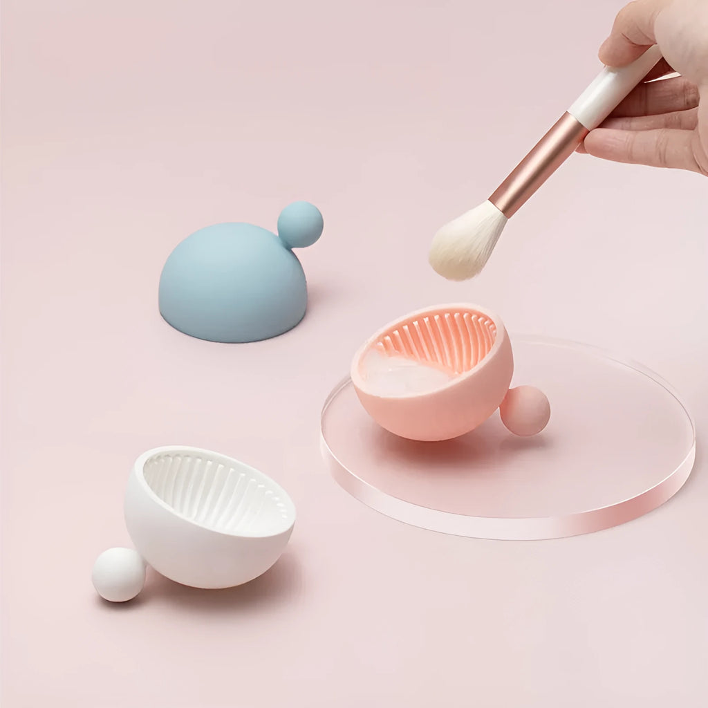 Small silicone makeup brush cleaning scrub tray in white with raised textured centre for removing foundation residue