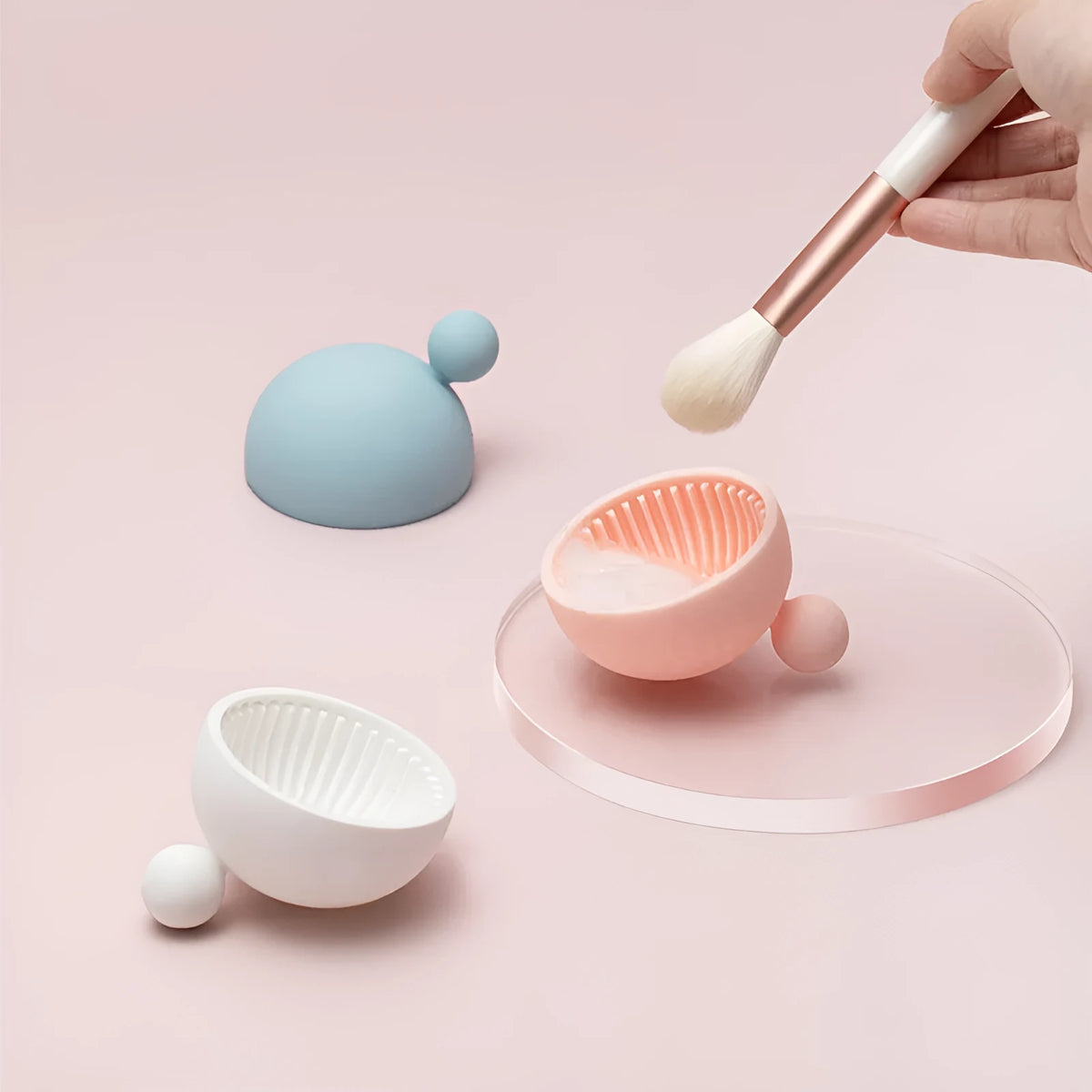 Small silicone makeup brush cleaning scrub tray in white with raised textured centre for removing foundation residue