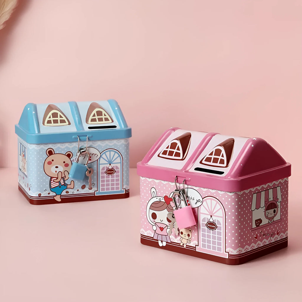 Blue and pink house-shaped tinplate piggy bank for coins on a wooden desk.