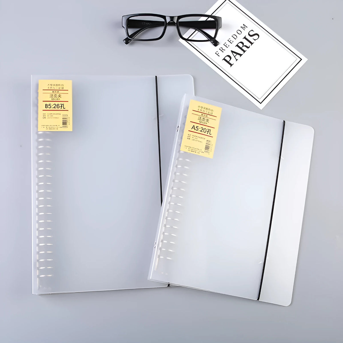 A5 loose-leaf notebook with 26-hole binder system showing horizontal line ruling on paper