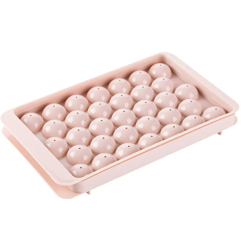Sky blue and pink plastic round ice ball mould trays with 18 and 33 grids.