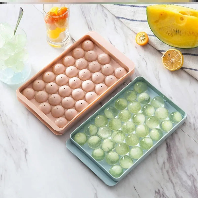 Sky blue and pink plastic round ice ball mould trays with 18 and 33 grids.