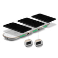 Black and white 3-in-1 wireless charging pad for phone, Apple Watch, and AirPods on a desk.