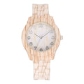 Retro quartz watch with wood grain dial and beige silicone strap on a wrist.