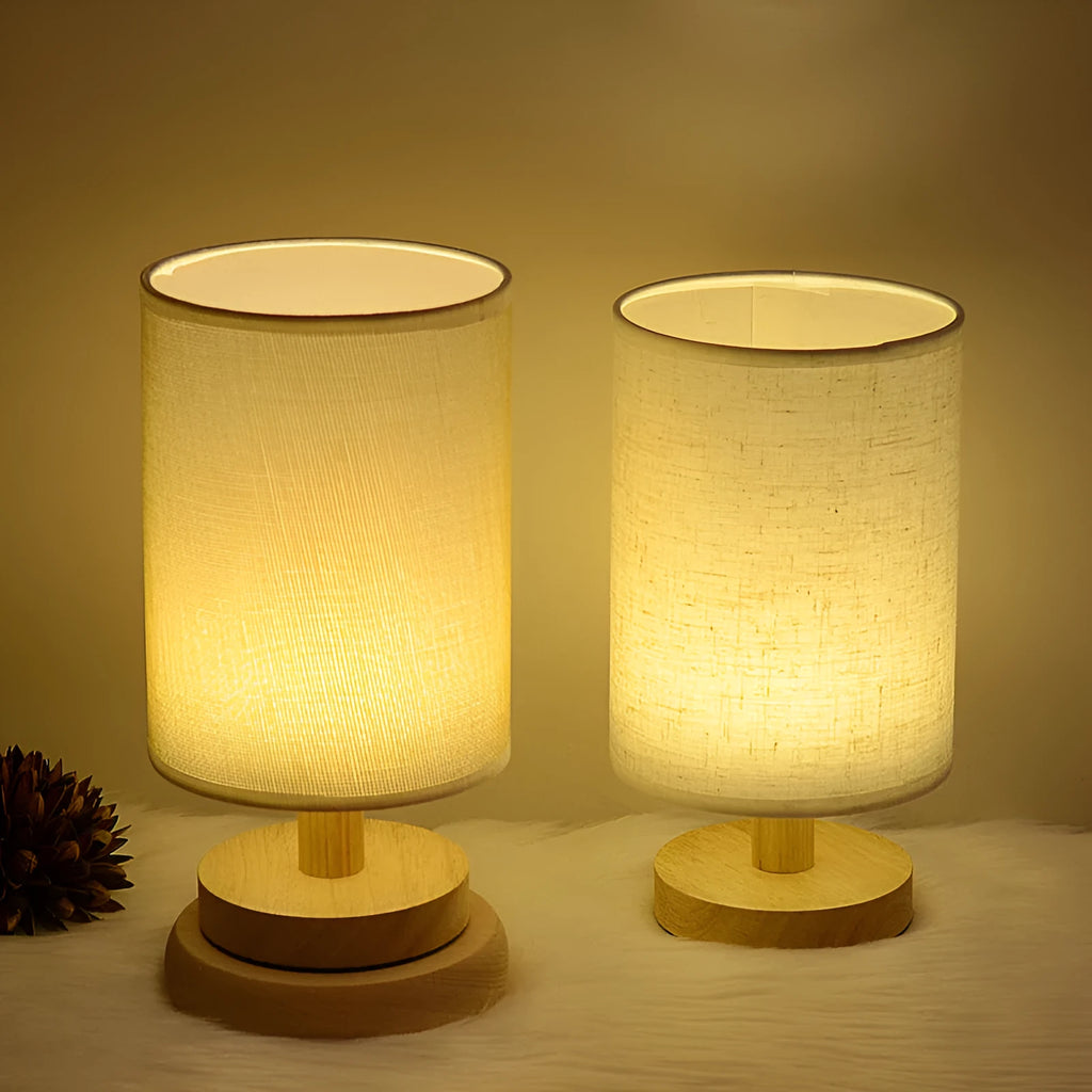 Solid wood cloth cover LED table lamp with grey linen shade and USB cable on a wooden desk