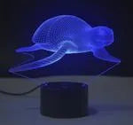 Compact colourful 3D LED table lamp with acrylic panel on a black ABS base, showing gradient light effects.