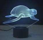 Compact colourful 3D LED table lamp with acrylic panel on a black ABS base, showing gradient light effects.