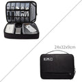 Cube-shaped polyester digital storage bag in black with zippered opening for cables and gadgets