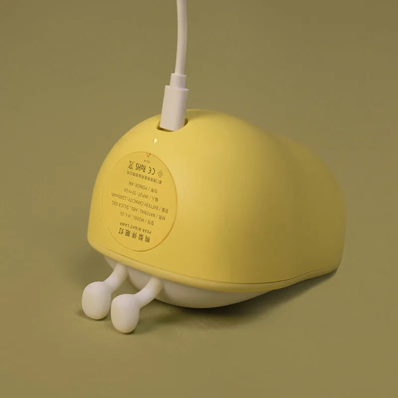 Silicone pear-shaped night lamp in warm yellow colour with compact dimensions