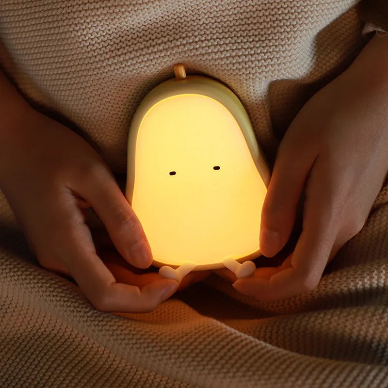 Silicone pear-shaped night lamp in warm yellow colour with compact dimensions