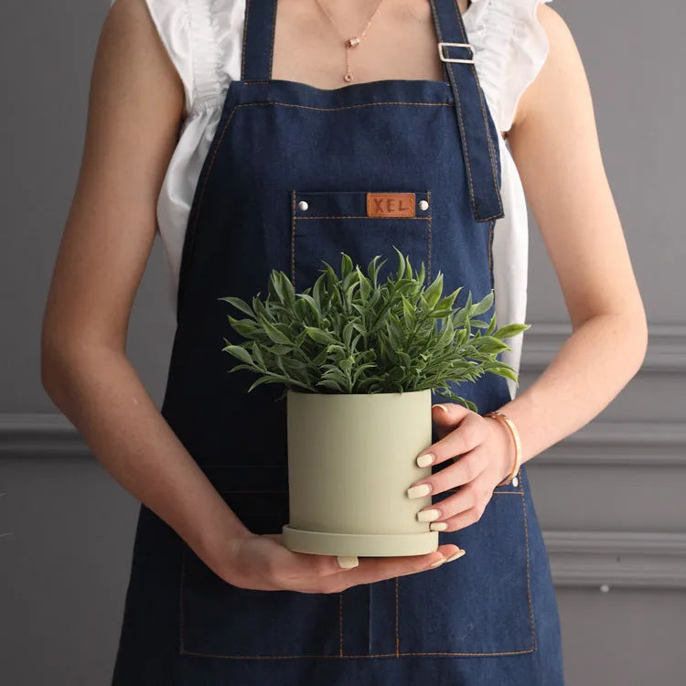 Cylindrical Nordic style ceramic succulent planter with drainage hole on wooden table
