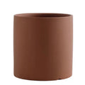 Cylindrical Nordic style ceramic succulent planter with drainage hole on wooden table