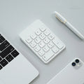 Wireless Bluetooth keyboard and mouse set in cherry blossom pink, white, or black, compatible with Apple devices.