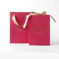 Small cardboard gift box set with matching handbag and raffia in blue, pink, red, or white.