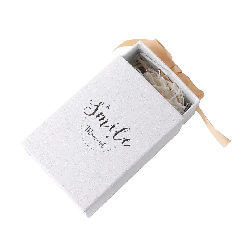 Small cardboard gift box set with matching handbag and raffia in blue, pink, red, or white.