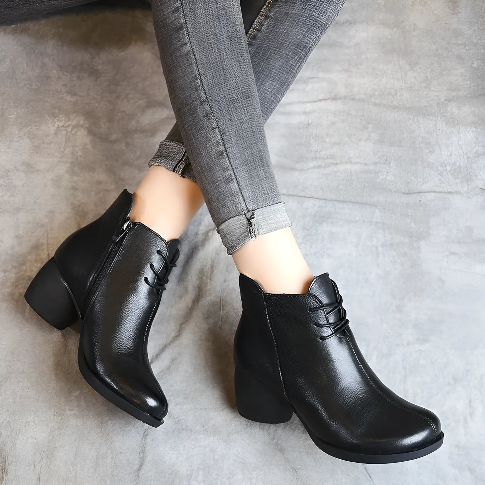 Black women's leather Martin boots with a thick heel and round toe on a white background.