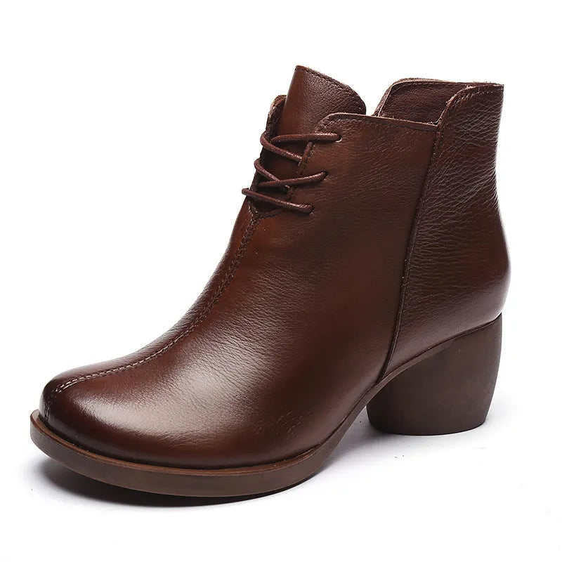 Black women's leather Martin boots with a thick heel and round toe on a white background.