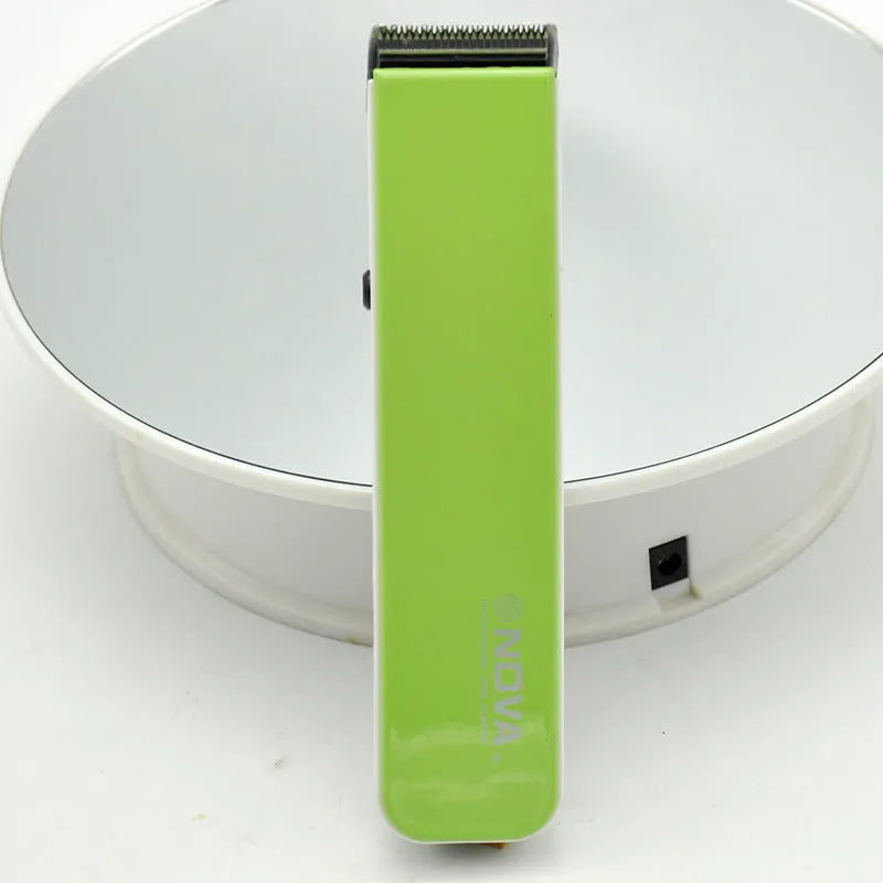 Electric hair clipper in multiple colours showing removable blade head and AA battery compartment.