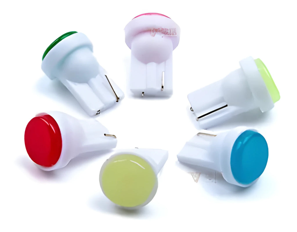 Close-up of a small T10 automotive LED bulb showing its 3D COB light source and compact rectangular shape.