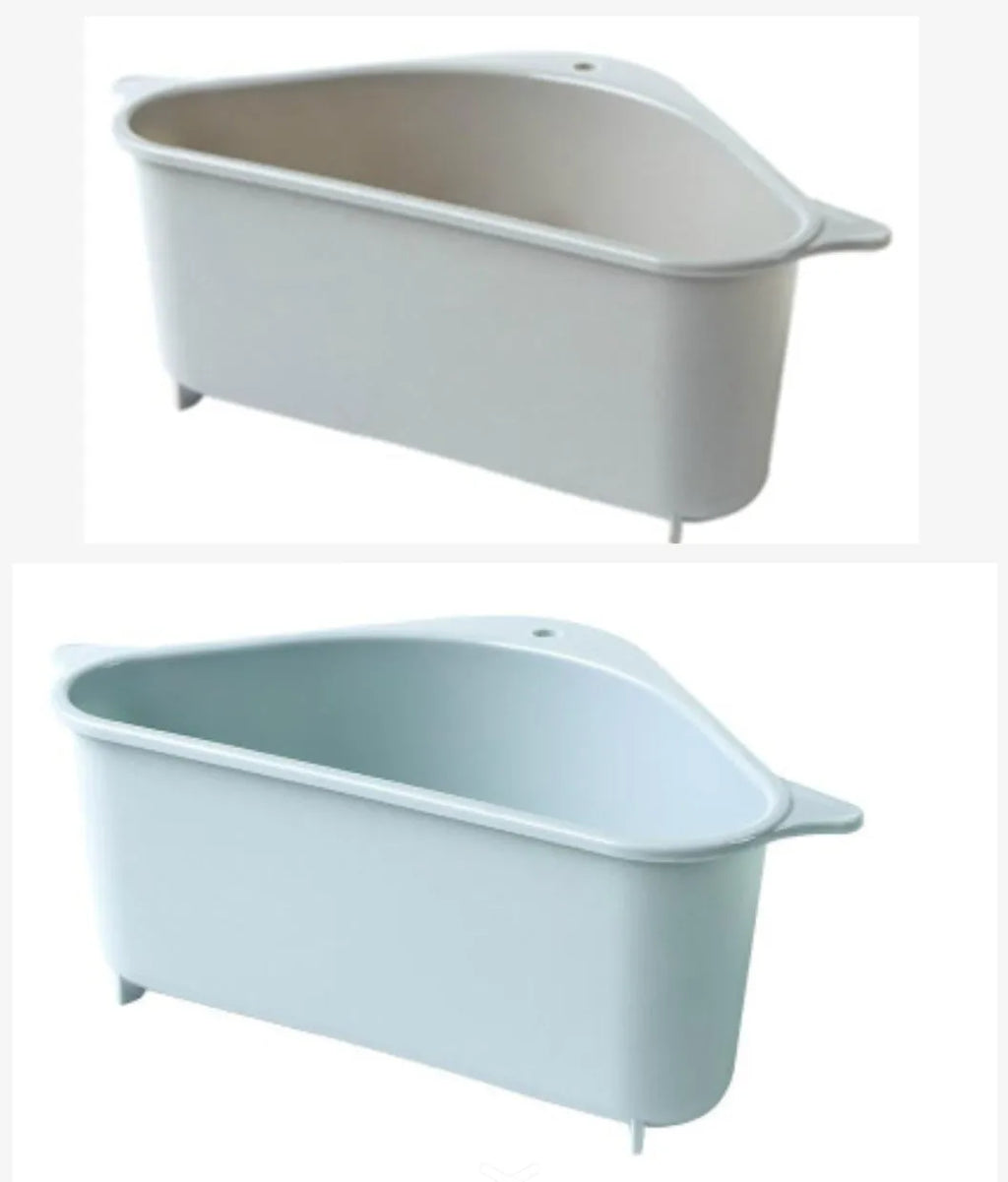 Triangular beige plastic kitchen sink storage rack with suction cup mount holding a sponge.