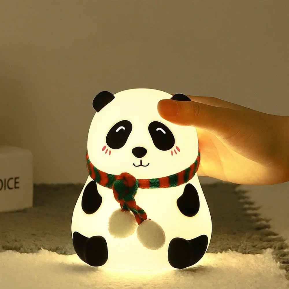 Panda-shaped silicone night light with USB cable on a table.