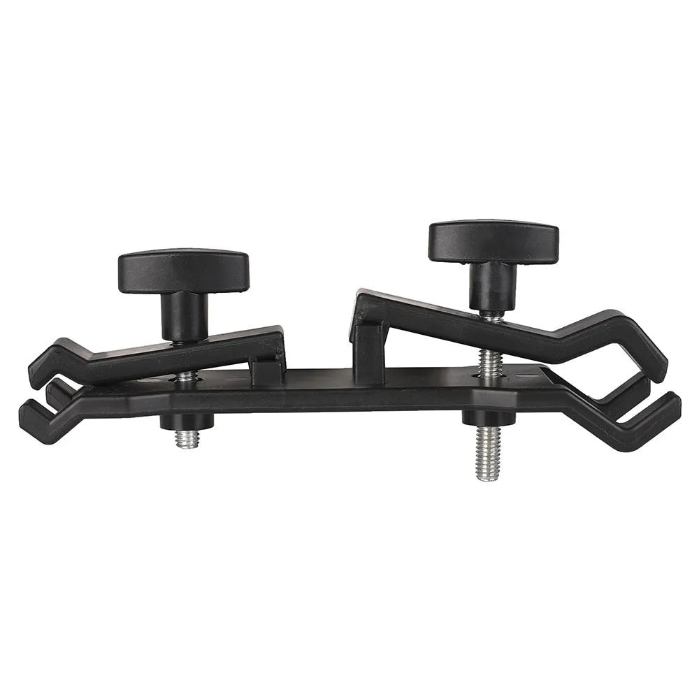 Black ABS umbrella clip attached to camera tripod shaft with umbrella in mounting position
