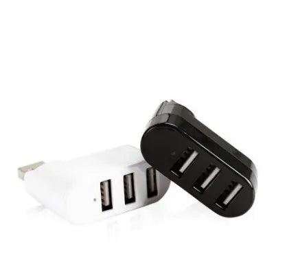 Black and white USB hub with a spinning multi-interface design on a desk.