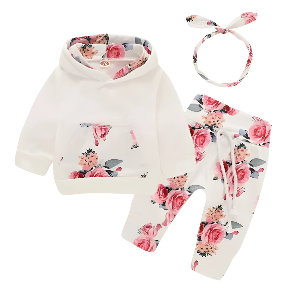 White cotton hooded tracksuit romper for a baby girl, showing long sleeves and full-length trousers.