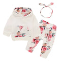 White cotton hooded tracksuit romper for a baby girl, showing long sleeves and full-length trousers.