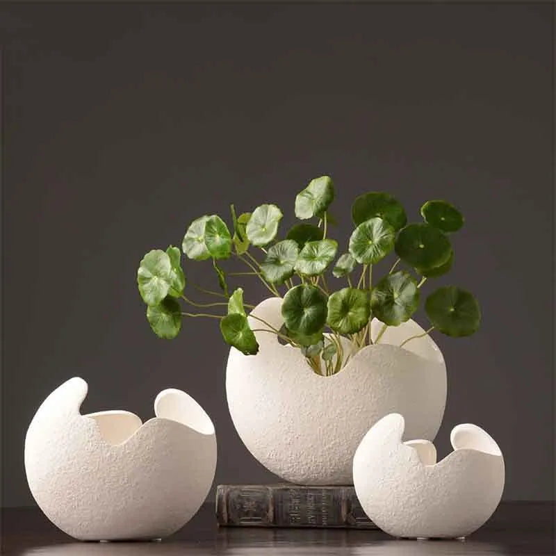 White ceramic countertop vase in simple modern style, shown in large medium and small sizes for living room desktop or study