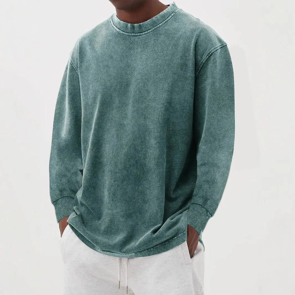 Man wearing a slim fit long sleeve t-shirt in a solid colour, with options in sky blue, green, gray, black, and camel.