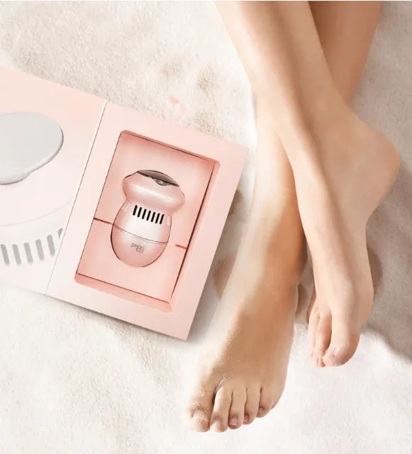 Beige and white USB-charged electric foot file grinder with vacuum system and two diamond grinding heads.