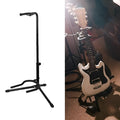 Black foldable metal guitar stand with rubber protective pads, holding a guitar.