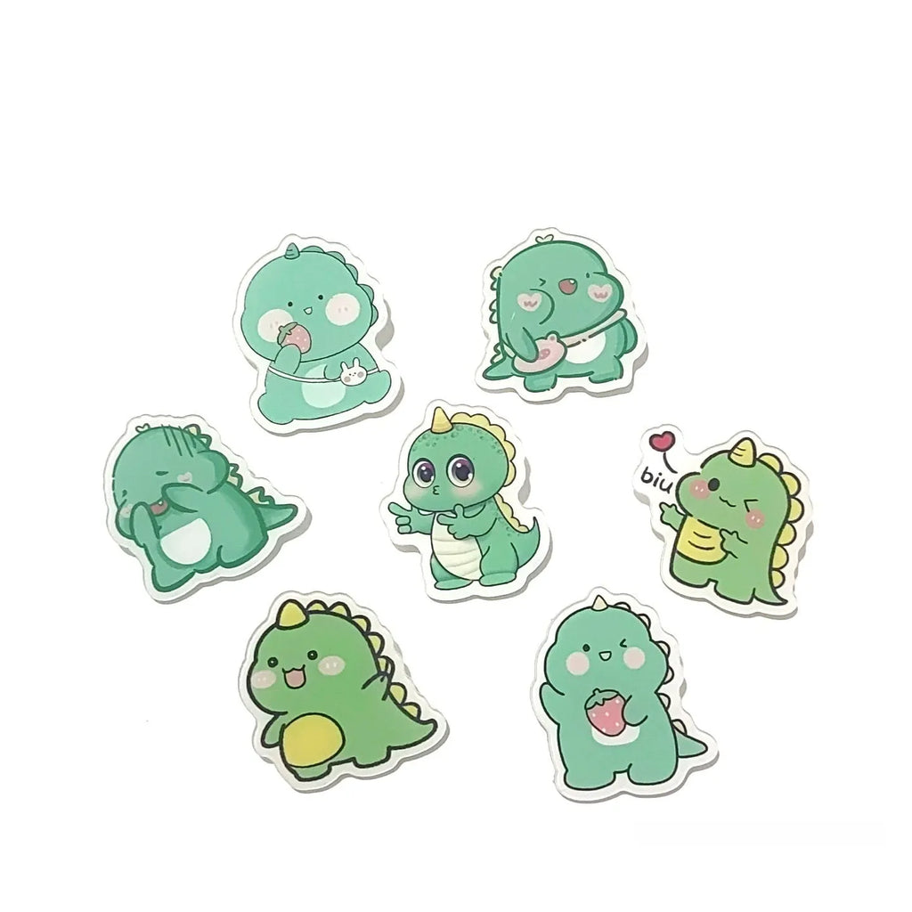Cartoon dinosaur acrylic badge brooch with printed design and pin fastening, shown in one of twelve colour styles