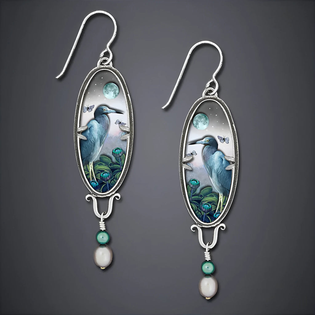 Silver-coloured drop shape earrings with a retro bird and flower electroplated design.