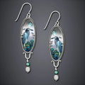 Silver-coloured drop shape earrings with a retro bird and flower electroplated design.