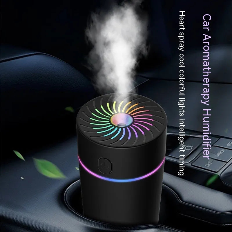 Compact black car USB mini humidifier with aromatherapy function on a car dashboard.