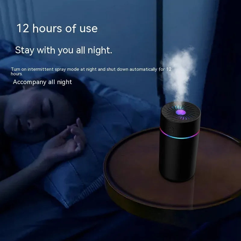 Compact black car USB mini humidifier with aromatherapy function on a car dashboard.