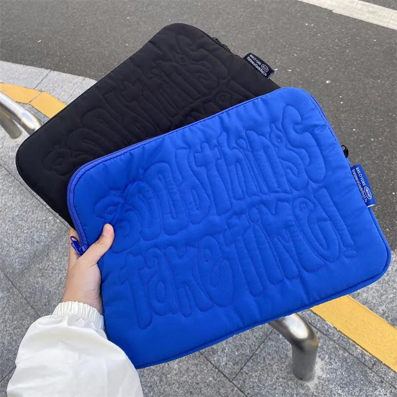 Embroidered blue silk laptop liner bag with letter pattern and cotton lining on a white background