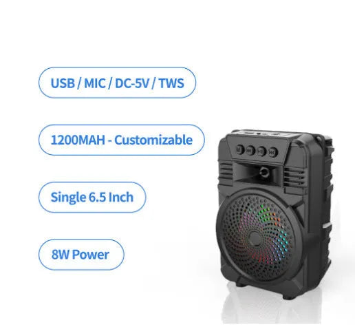 Black portable Bluetooth speaker with microphone and subwoofer on outdoor setting