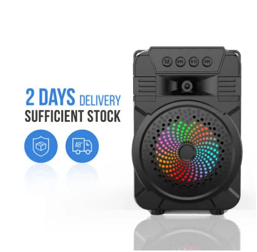 Black portable Bluetooth speaker with microphone and subwoofer on outdoor setting