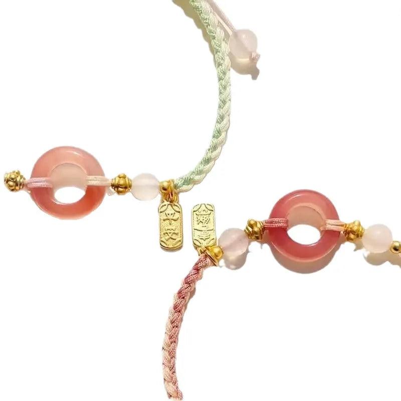 Women's woven bracelet with peach blossom minority ethnic design and peace buckle closure