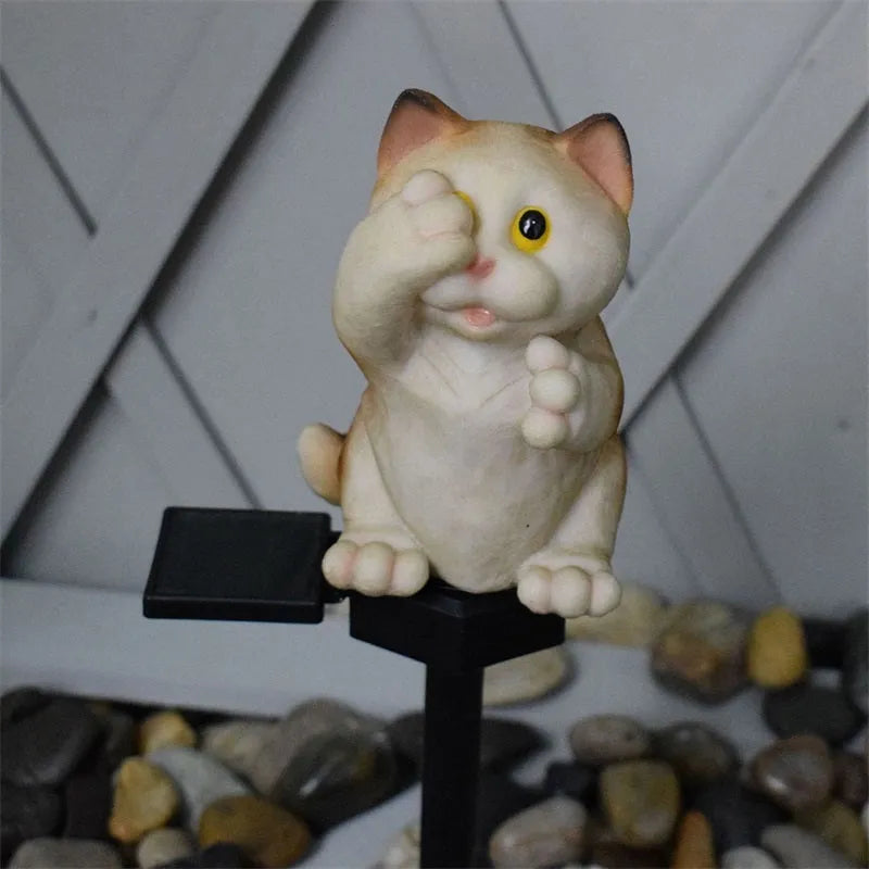 Brown resin cat-shaped solar garden light for outdoor decorative lighting.