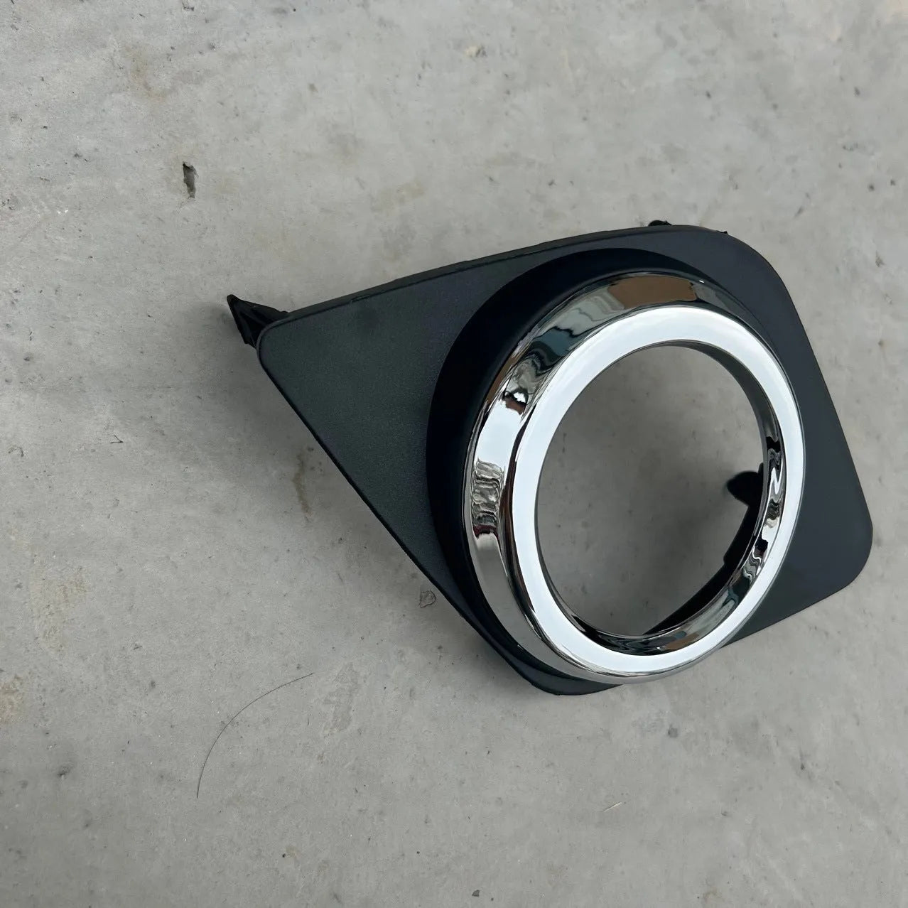 Black anti-fog lamp cover accessory for Toyota RAV4 front bumper, suitable for driver or passenger side.