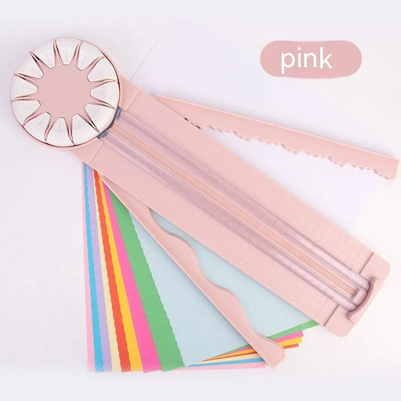 Pink and black 12-in-1 dotted plastic paper cutting machine on a white background.