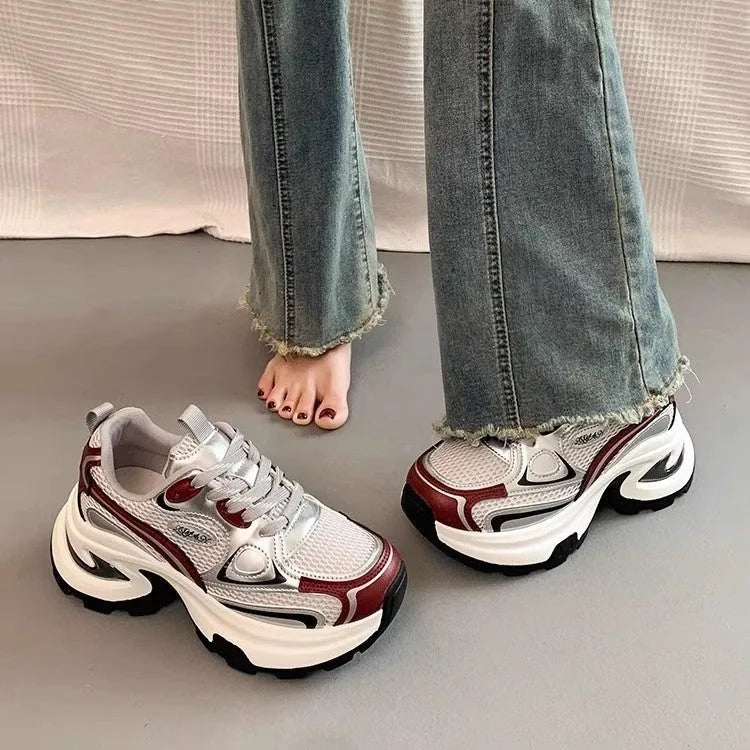 Women's red and silver mesh platform sneakers with flat heel and lace-up front.