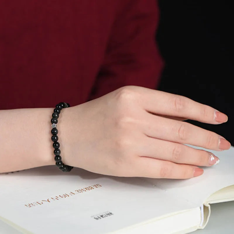 Natural obsidian bracelet with S925 silver flower accessories showing 6mm constellation design and dragon phoenix decorations