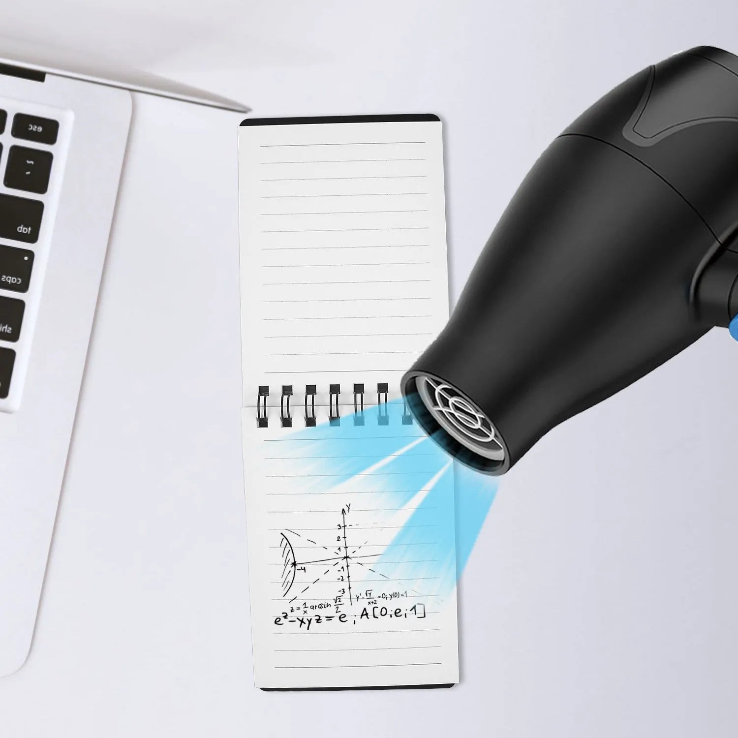 Spiral-bound black business notepad with pen and cleaning rag on a desk.